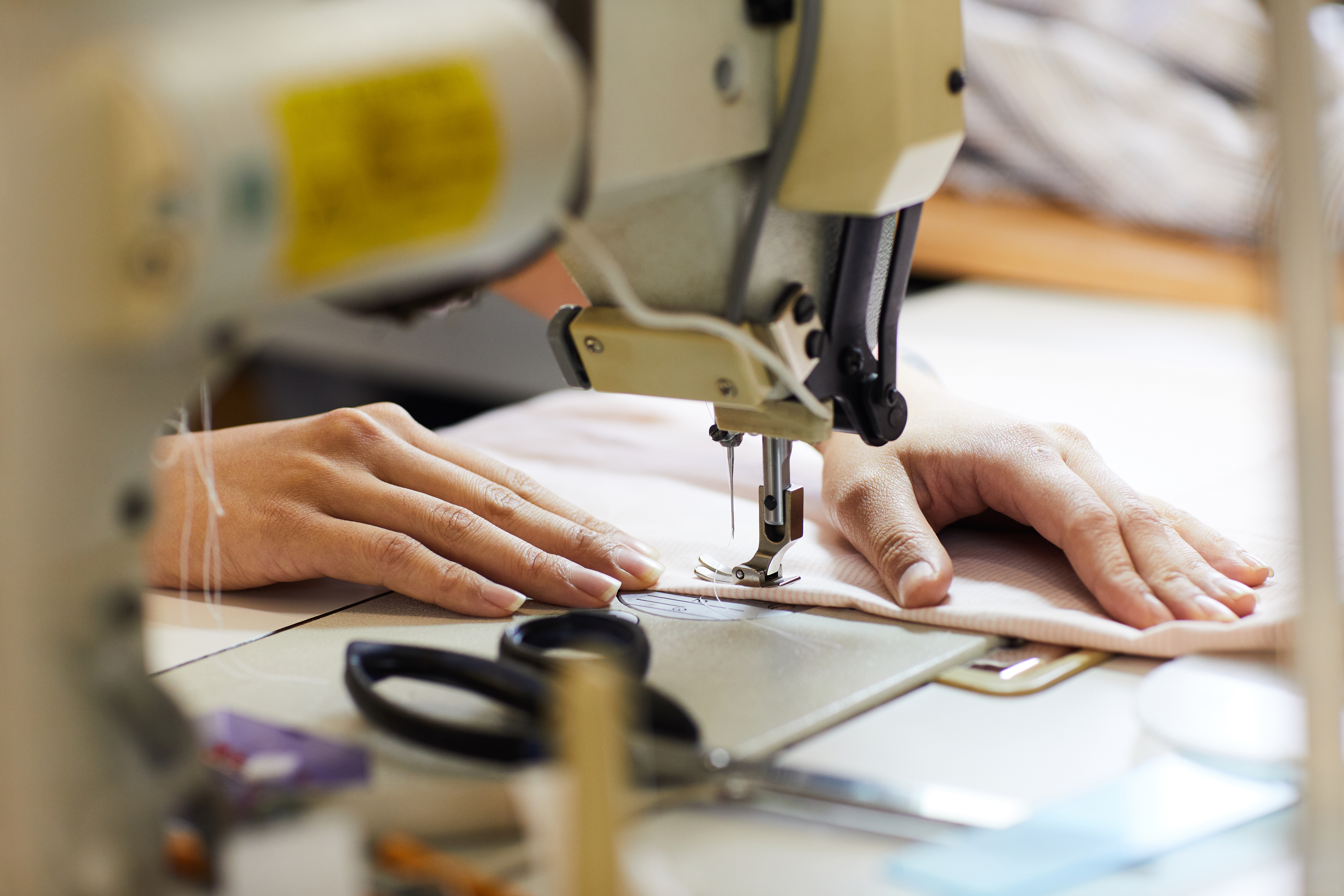 Woman sewing on sewing machine